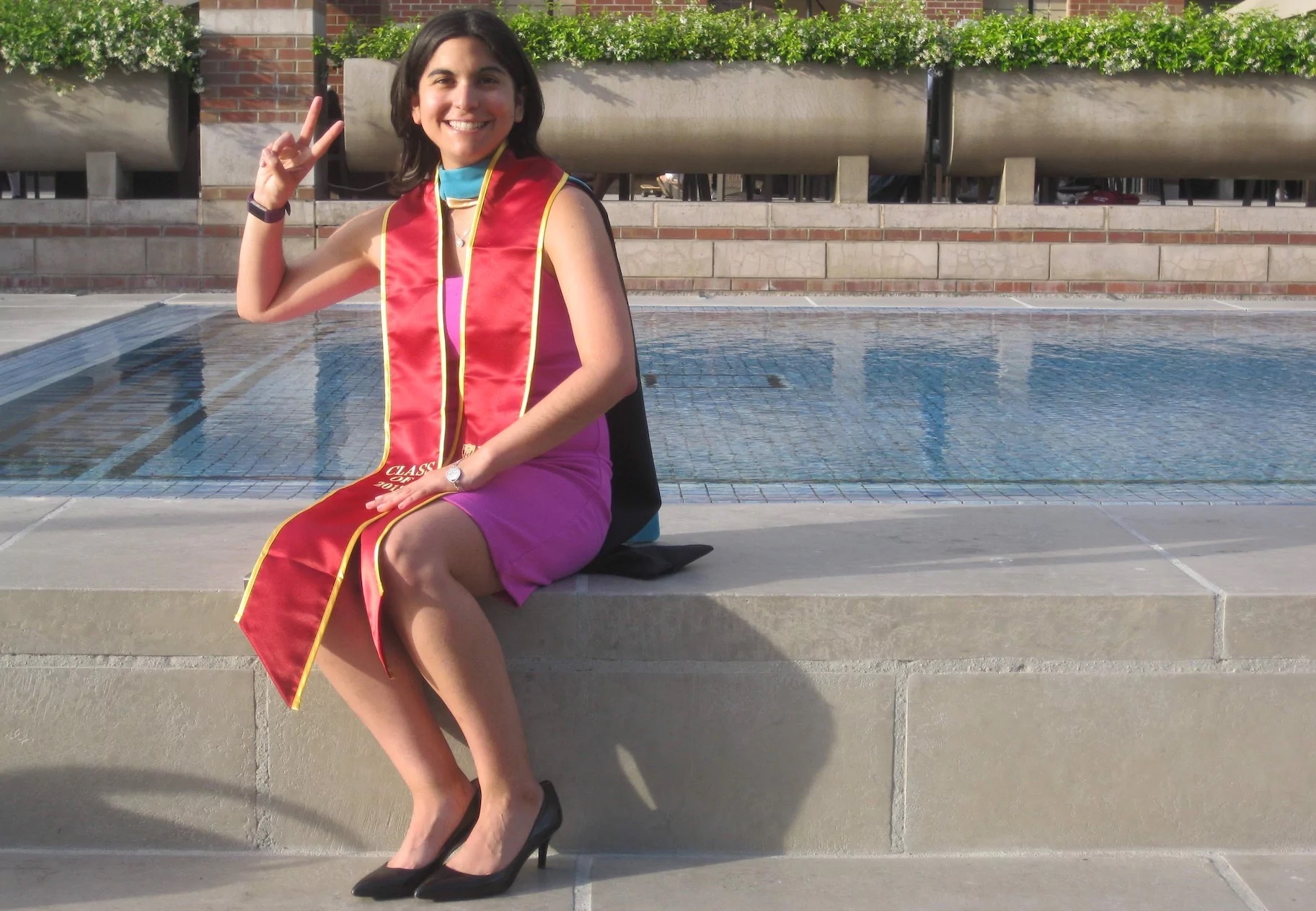 Erica Robles poses on campus after graduation 