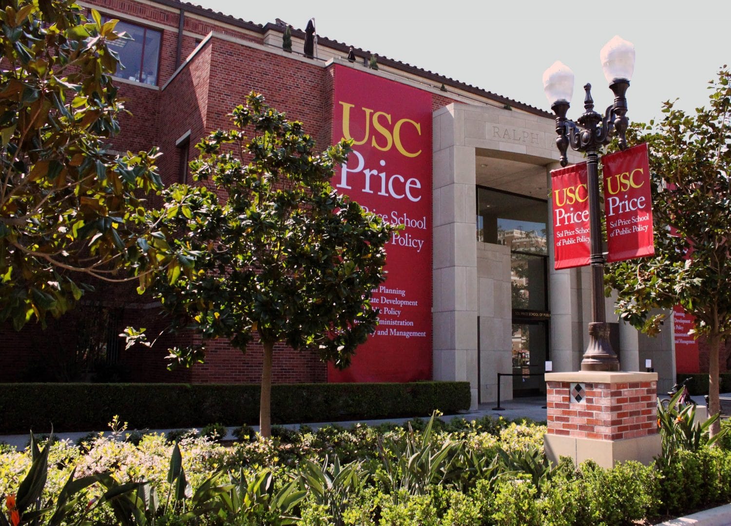Campus building with red USC Price banners.